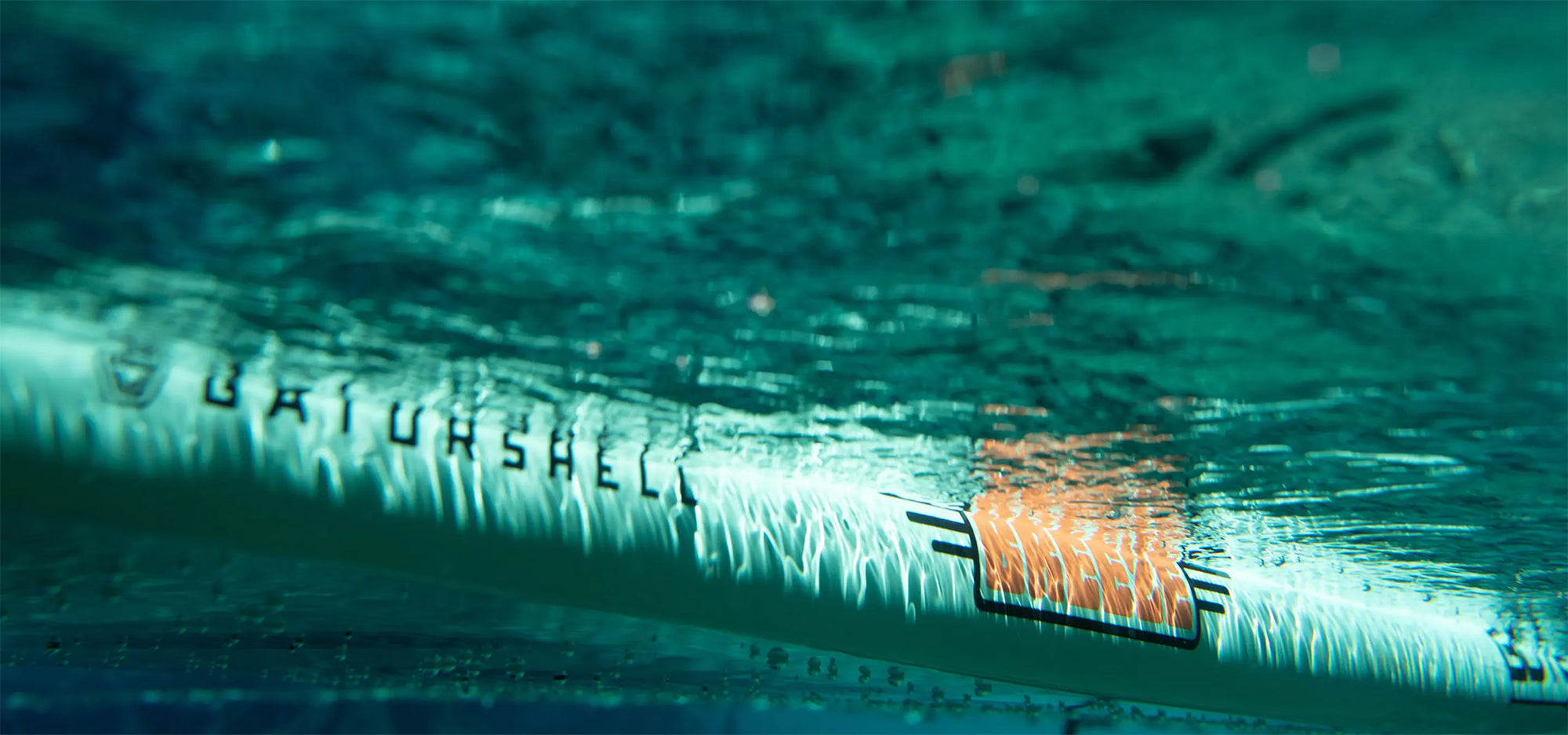 Underwater view showing Breeze Gatorshell board with orange logo detail.