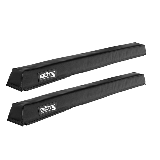 Angled view of a pair of black padded Roof Rack Pads with BOTE logo patches.