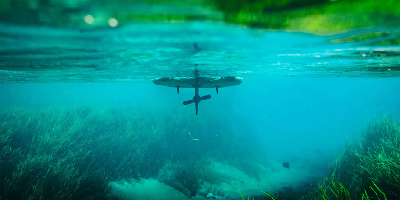 Underwater view of LONO Aero kayak gliding above clear blue water and seagrass.