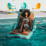 A woman lounging on the Inflatable Hangout Lounge Classic