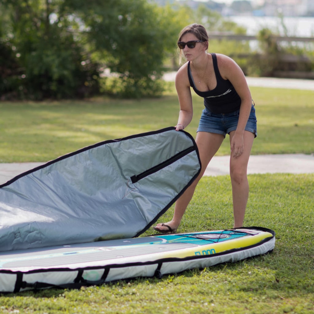 Woman putting her 12' Flood into a board bag