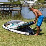Man putting his Rackham Paddle Board into a board bag