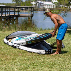 Man putting his Rackham Paddle Board into a board bag