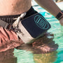 Lifestyle view of Highwater Hitchhiker Black worn across waist in shallow water.