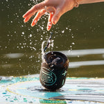 Side image of speaker falling on water