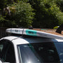 Paddle Board strapped to the top of a Quick Strap Board Rack on top of a sedan