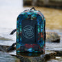 Highwater backpack sitting on some rocks near the water