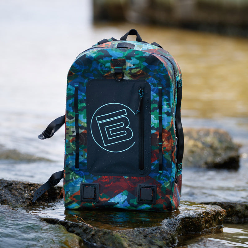 Highwater backpack sitting on some rocks near the water