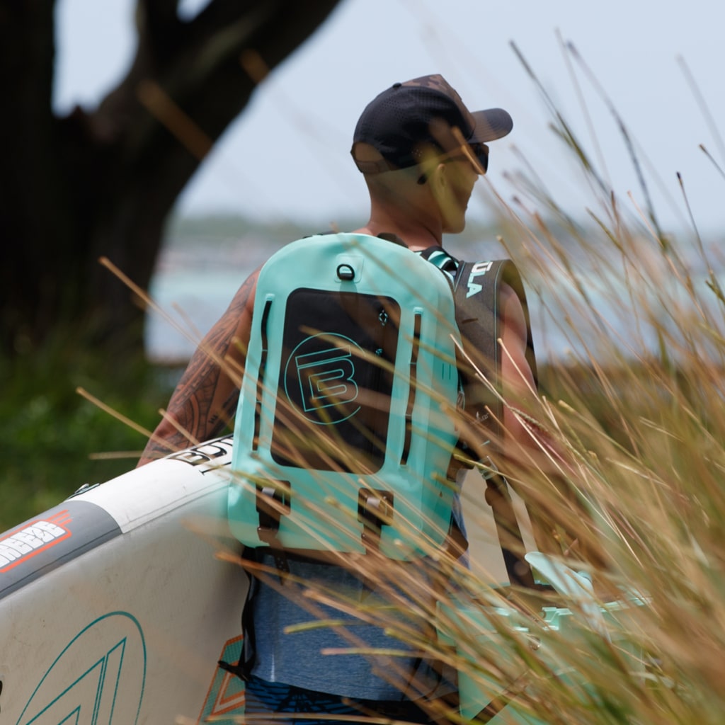 Man wearing the Highwater Backpack Seafoam while carrying his Breeze Aero