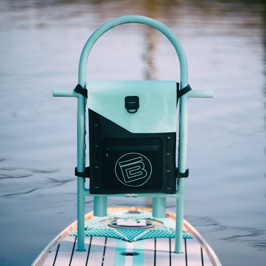 Highwater Tackle Pouch Seafoam mounted to a paddle board rack above the water.