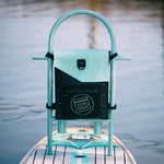 Highwater Tackle Pouch Seafoam mounted to a paddle board rack above the water.