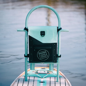 Highwater Tackle Pouch Seafoam mounted to a paddle board rack above the water.