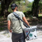Man using the KULA Travelink Carry Sling to carry his KULA 5 Cooler