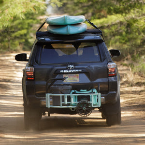 Image of back of the car showing hitch with two boards on top of car