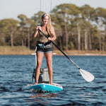 Woman paddling her inflatable paddle board with a 3-piece adjustable SUP paddle grey