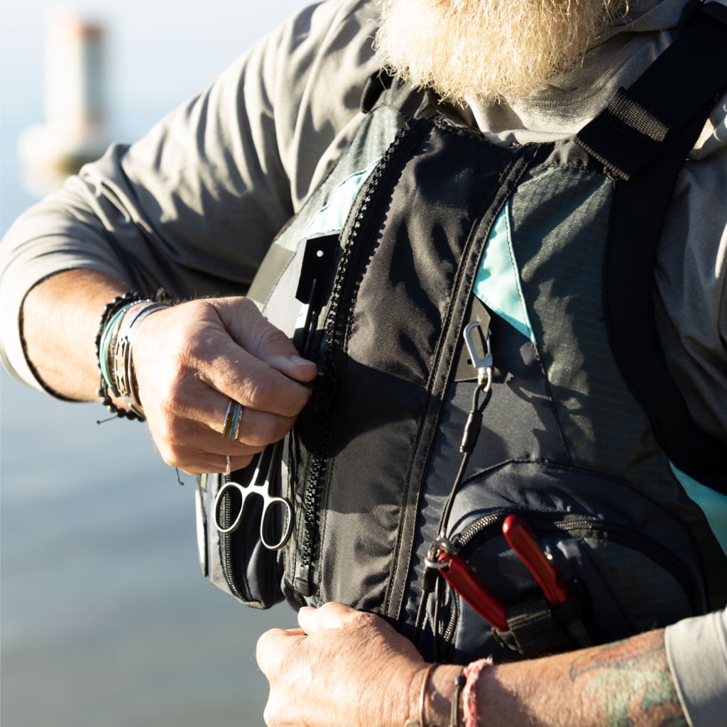 Zipping up the BOTE Adult Fishing PFD Vest